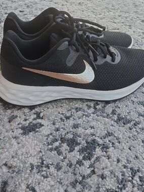 Nike Women's Black Sneakers with Metallic Gold Swoosh